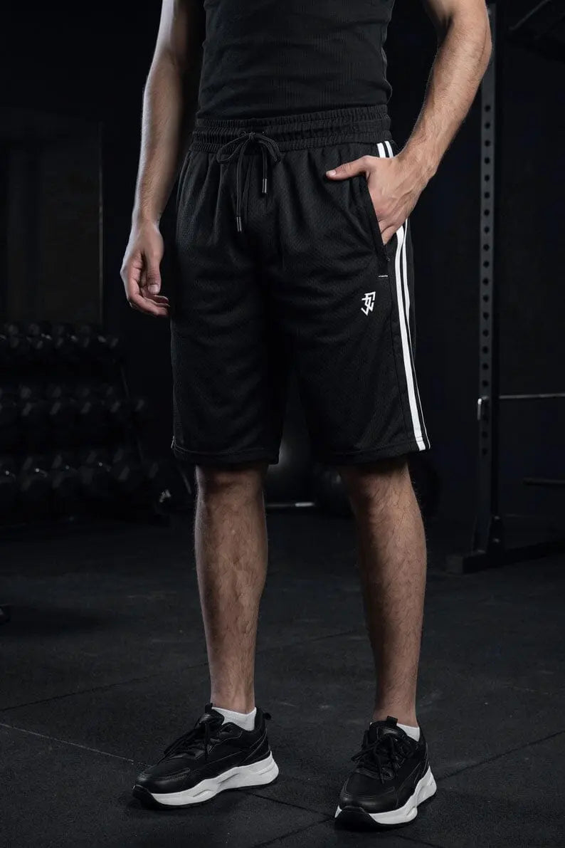 Man wearing black athletic shorts with white side stripes, rear view at the gym