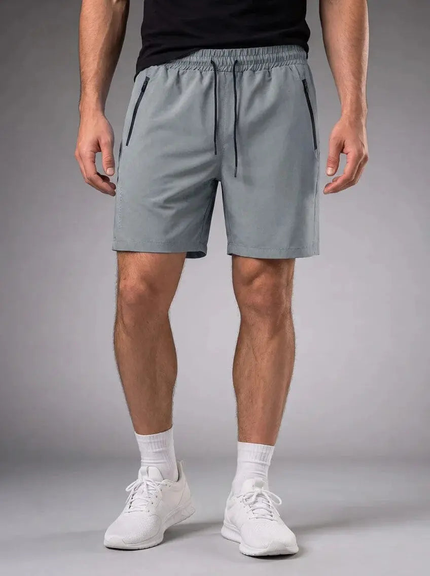 Rear view of men’s light gray athletic shorts with elastic waistband and back pockets