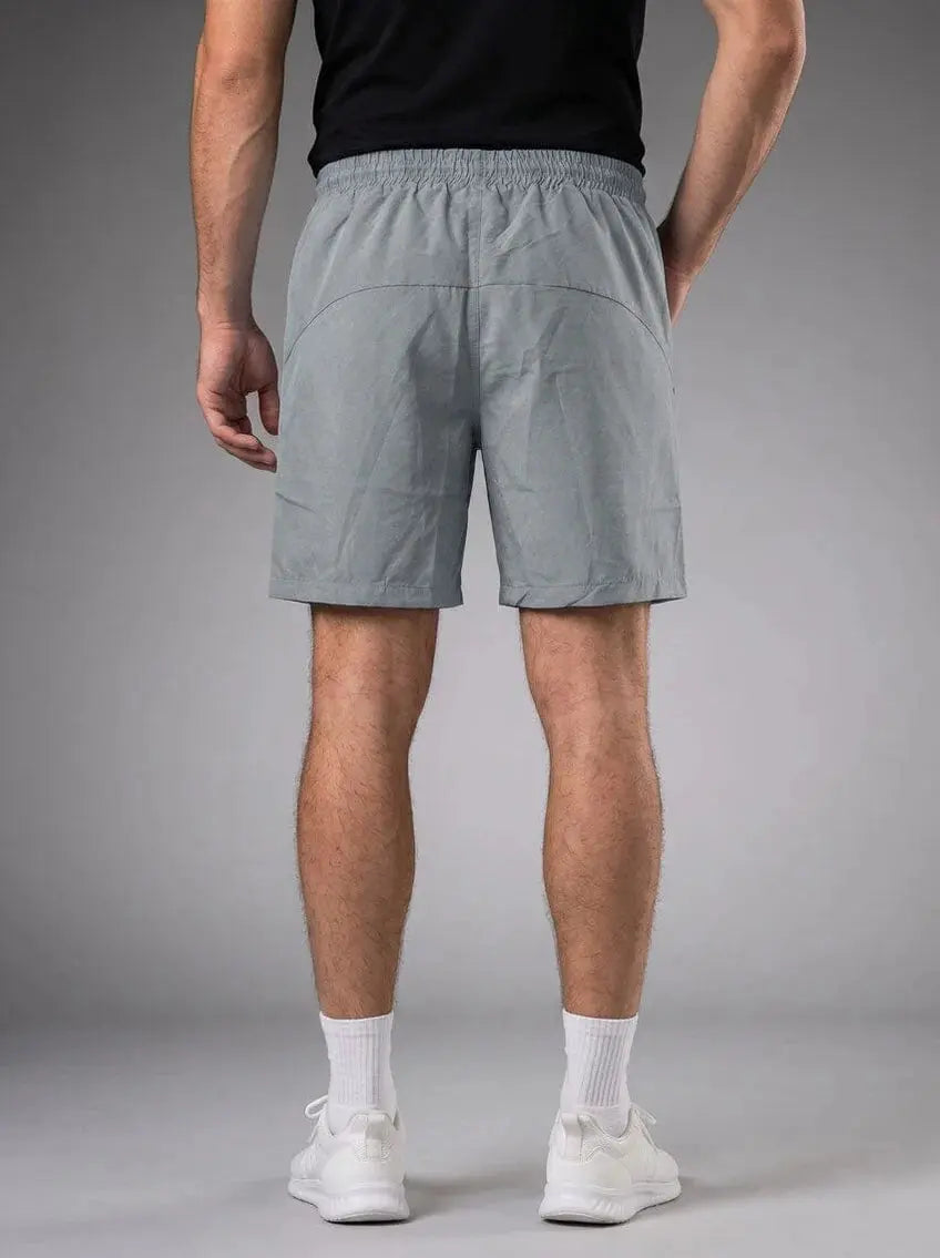 Rear view of men’s light gray athletic shorts with elastic waistband and back pockets