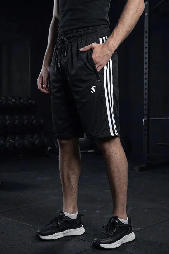 Man wearing black athletic shorts with white side stripes and drawstring at the gym