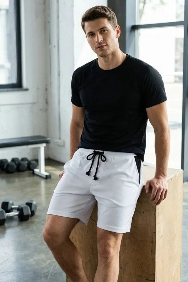 “Male model wearing white drawstring shorts from wearo.”